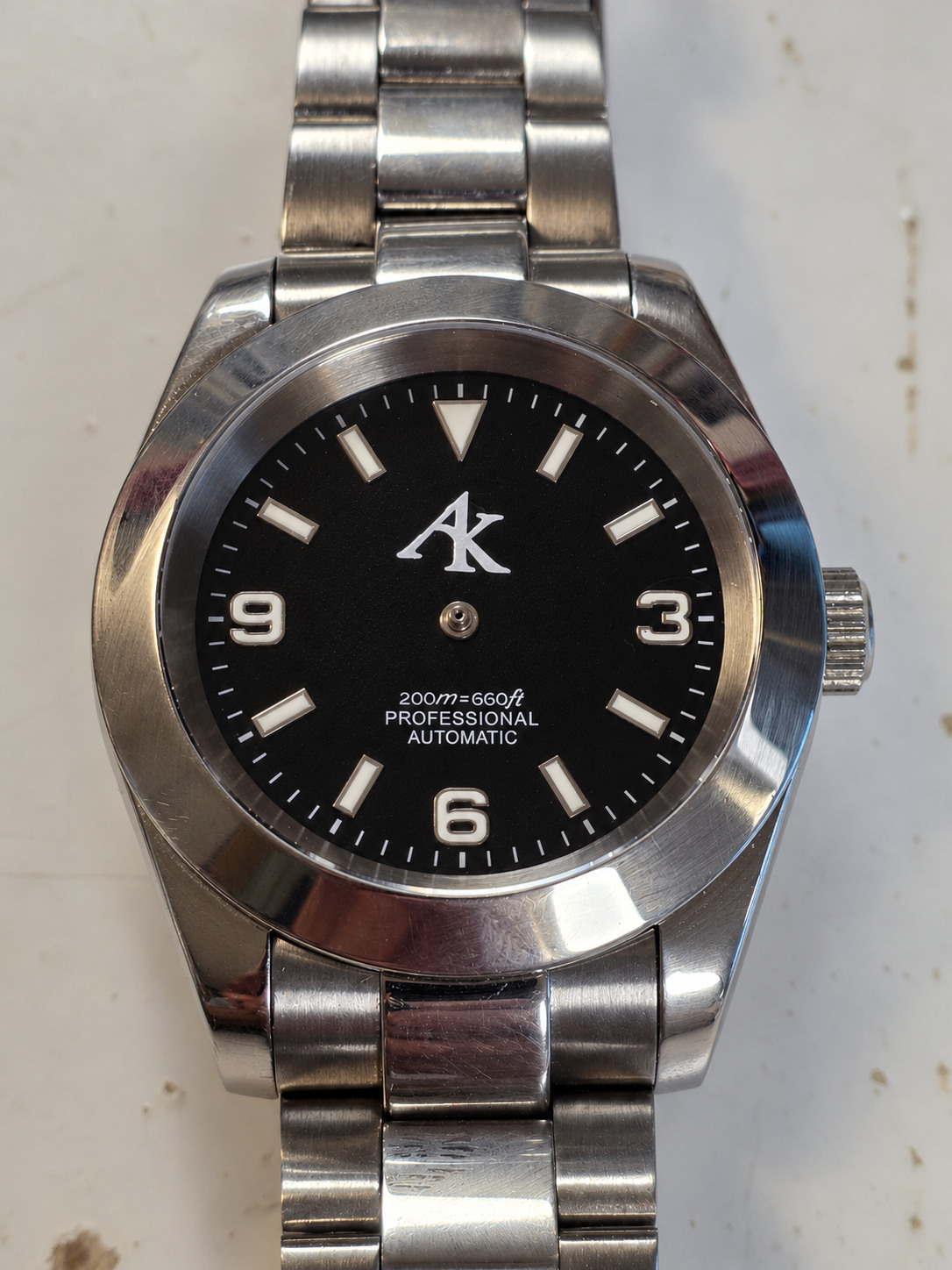 Illustrated AK001 dial with stationary hands digitally removed